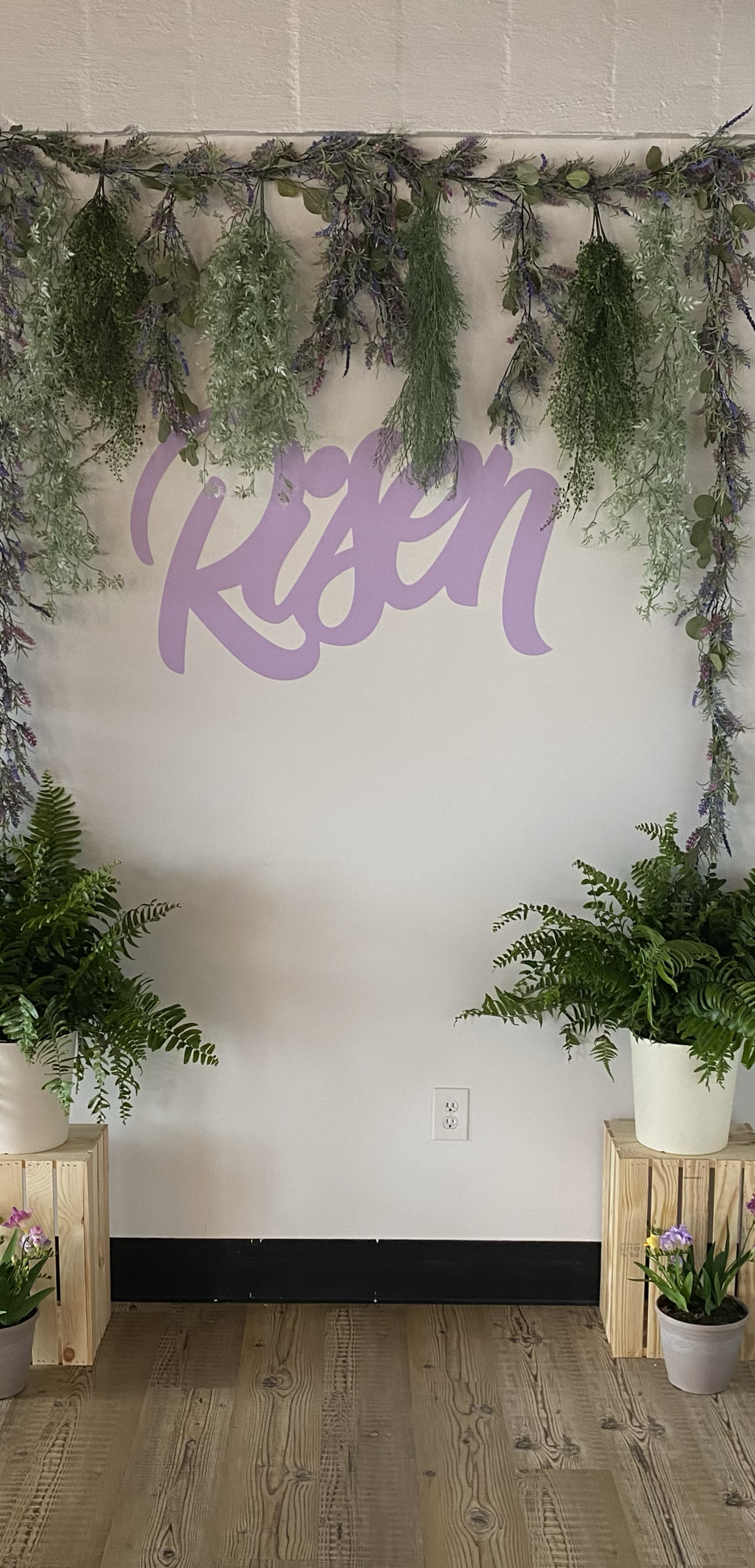 Purple Vinyl Cut Out of the word Risen on a Wall